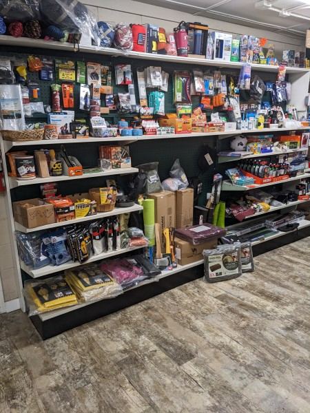 Camping and hiking supplies on store shelves.