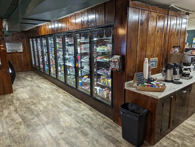 Self-serve coffee bar with fresh coffee, cups, and creamer.