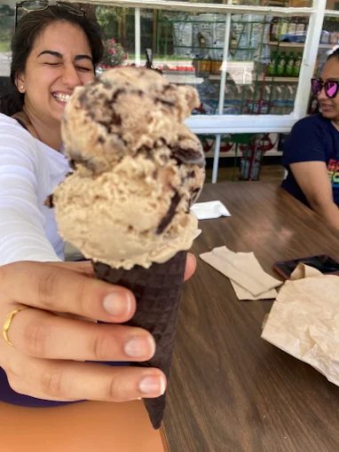 A hand-dipped ice cream cone piled high at the store's outdoor tables.